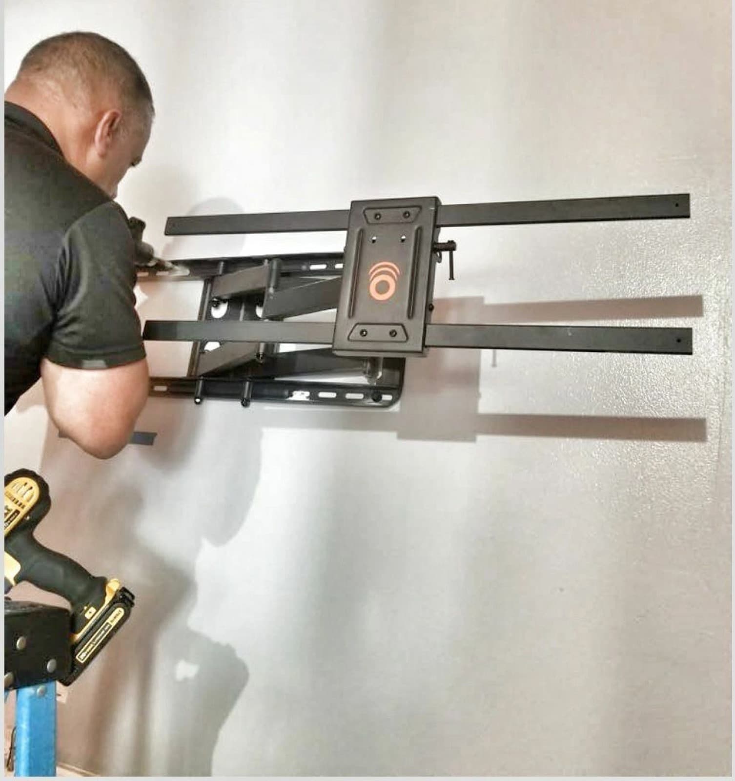 Installer fitting a full-motion TV mount
