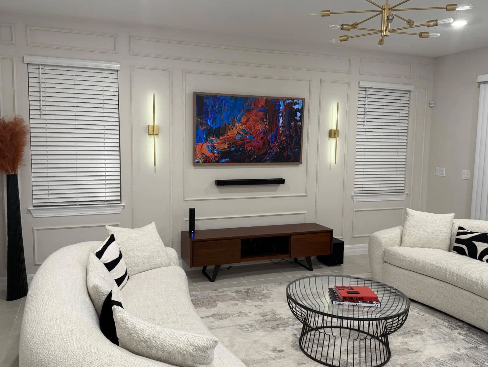 TV on a paneled accent wall with a soundbar below