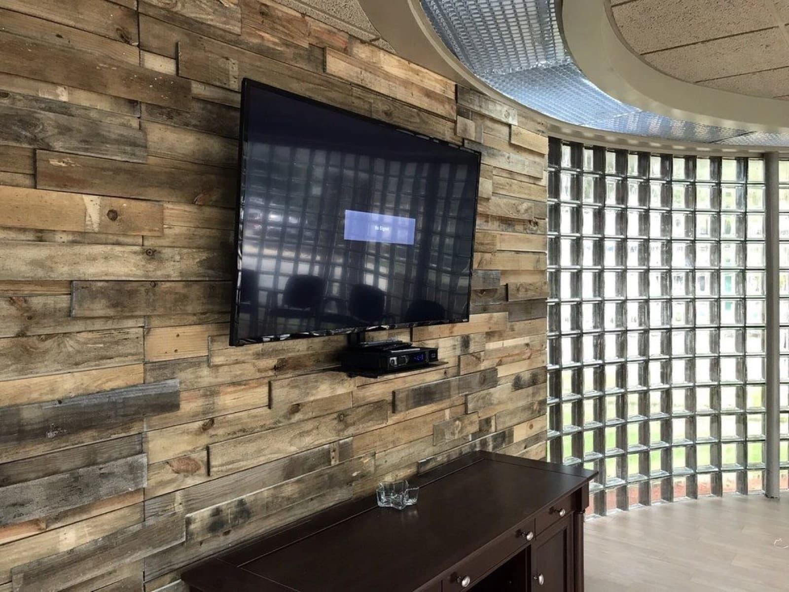 TV mounted on a reclaimed wood accent wall